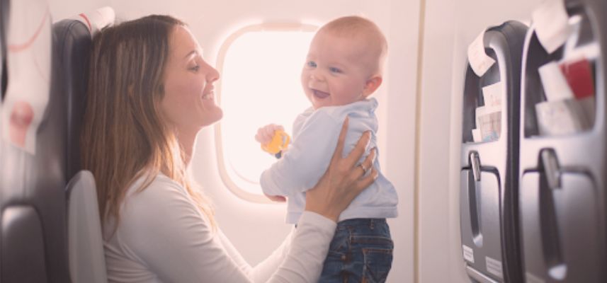 mom holding baby on flight